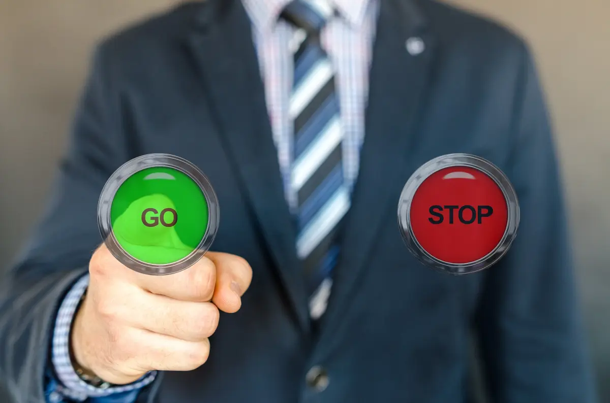 Ein Mann, der die Start- und Stopp-Taste drückt. Bild von Consulting-ahead!